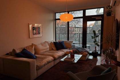 A cozy living room lit in orange light.